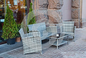 Wicker rattan furniture on pavement sidewalk cafe