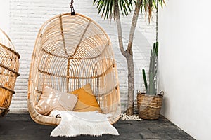 Wicker rattan hanging lounge chair in loft cafe