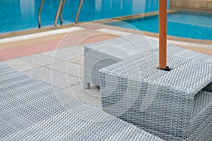 Wicker rattan pool sun bed deckchair at swimming pool