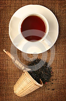 A wicker scoop with herb tea leaves