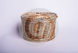 Wicker small basket on white background, handicraft vintage cask