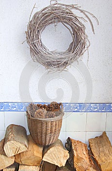 Wicker wreath, pine cones and woodblocks for the fireplace