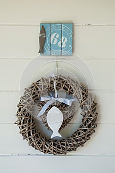 Wicker wreath with white wooden fish