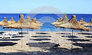 Wickerwork sun umbrellas on the beach