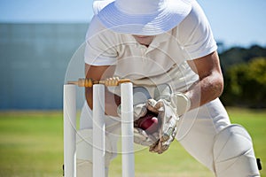 Wicketkeeper catching ball behind stumps