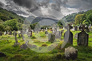 Ancient graves with Celtic crosses in Glendalough Cemetery, Wicklow, Ireland