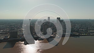 Wide Aerial shot of Mississippi River waterfront and downtown city skyline New Orleans, Louisiana