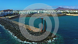 Wide aerial view of a beautiful statue on a water dem in Lanzarote island, Spain.