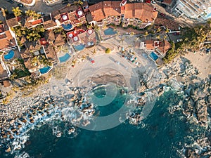 Wide aerial view of Conchas Chinas Beach in Puerto Vallarta Mexico. Villas, waves, turquoise water
