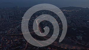 Wide Aerial View over Istanbul New Financial District at Dusk with Freeway traffic, tilt down