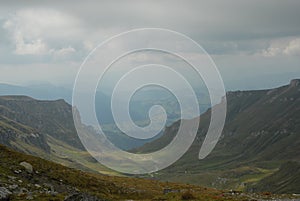 wide alpine valley with mountain paths