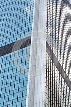 Wide angle abstract background view of steel light blue high rise commercial building skyscraper made of glass exterior