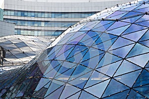 Wide angle abstract background view of steel light blue high rise commercial building skyscraper made of glass exterior