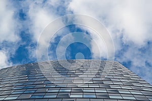 Wide angle abstract background view of steel light blue high rise commercial building skyscraper made of glass exterior