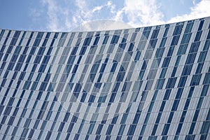 Wide angle abstract background view of steel light blue high rise commercial building skyscraper made of glass exterior