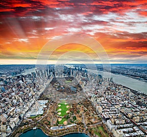 Wide angle aerial view of Midtown Manhattan and Central Park from helicopter at sunset, New York City