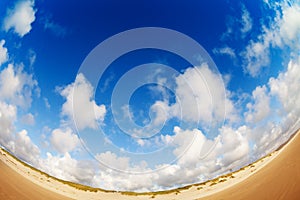 Wide angle cloudscape on the California sand beach