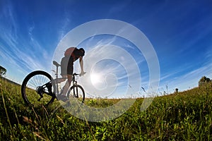 Wide angle of the cyclist with mountain bicyclist against beautiful landscape.