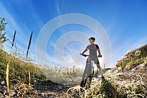 Wide angle of the cyclist with mountain bicyclist against beautiful landscape.