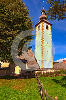 Wide angle landscape view of ancient John the Baptist Church. Iconic landmark in Bohinj Lake Bohinjsko jezero.