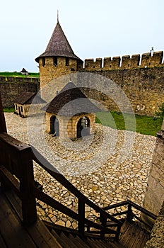 Wide-angle landscape view of courtyard with ancient stone buildings in the old medieval castle