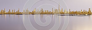 Wide angle panorama of downtown Dubai with Burj Khalifa. Low-poly miniature city. All buildings are made of gold.