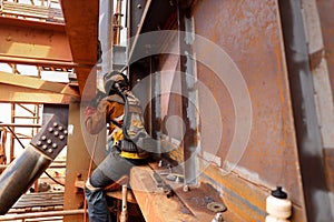 Wide angle pic of maintenance welder wearing safety red glove welding helmet with power air purifying respirator