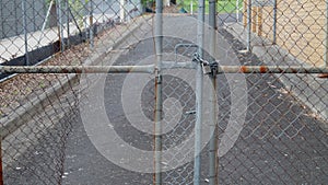 Wide Angle Pointlessly locked gate with Chain Link Dammage.