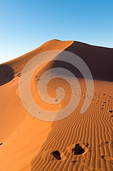 Wide angle shoot of footpath in desert dunes of Erg Chigaga.The gates of the Sahara, at sunrise. Morocco. Concept of travel and