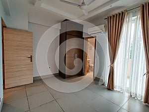 Wide angle shot of bedroom with airconditioner and colorful curtains
