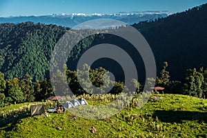 A wide angle shot of Camping in the hills of Himalayan region of Uttarakhand, India with visible Gomukh Glacier peaks in the