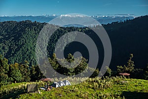 A wide angle shot of Camping in the hills of Himalayan region of Uttarakhand, India with visible Gomukh Glacier peaks in the