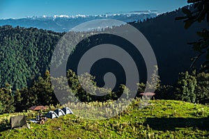 A wide angle shot of Camping in the hills of Himalayan region of Uttarakhand, India with visible Gomukh Glacier peaks in the
