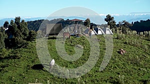 A wide angle shot of Camping in the hills of Himalayan region of Uttarakhand, India with visible Gomukh Glacier peaks in the