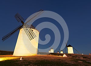 Wide angle shot of group of windmills in night