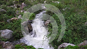 A wide angle shot of a river flowing through the forest with mountain surrounding in India. Dehradun city of uttarakhand