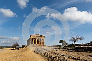 Wide-angle shot of Tempio della Concordia in Valley of the Temples near Agrigento, Sicily, Italy with shadows and blue sky