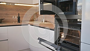 Wide angle tilt shot of modern white and wooden beige kitchen interior