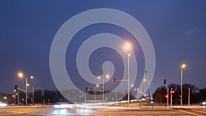 Wide angle time-lapse traffic jam on road in city in evening. Timelapse rush hour busy crossroad by bridge roadway. Cars