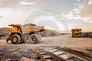 Wide angle of two Large Mining Dump Trucks for transporting ore rocks
