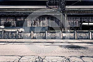 Wide angle view of abandoned industrial factory with grungy wall