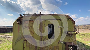 Wide angle view on broken and abandoned trailer on a field, sunny day, 4k footage