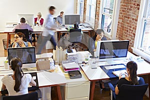 Wide Angle View Of Busy Design Office With Workers At Desks photo