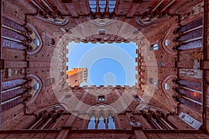 Wide angle view from the courtyard of Palazzo Pubblico to the famous Torre del Mangia.