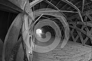 Wide angle view of a covered bridge with the word Hope painted on one board.