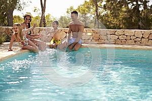 Wide Angle View Of Family On Vacation Having Fun By Pool