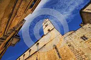 A wide angle view of the Franciscan monastery in Dubrovnik from Stradun street