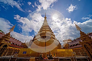 Wide-angle view of golden pagoda at Wat Phra That Cho Hae Temple in Phrae