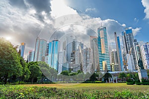 Wide angle view Hong Kong of skyscrapers and residential area square in city park with monument Sun Yat Sen Statue.