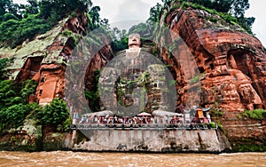Wide angle view of Leshan Giant Buddha or Dafo from river boat in Leshan China